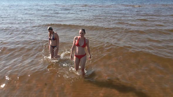 Two Women in Swimsuits Coming Out of Sea Towards Camera