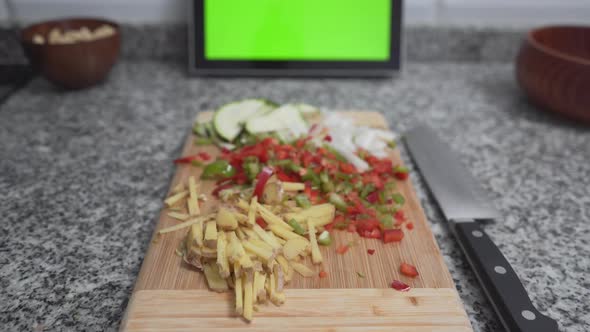 Woman Cutting Red Capsicum For Healthy Dish In The Kitchen