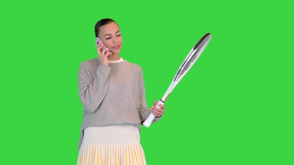 Young Woman Tennis Player Talking on the Mobile Phone on a Green Screen Chroma Key