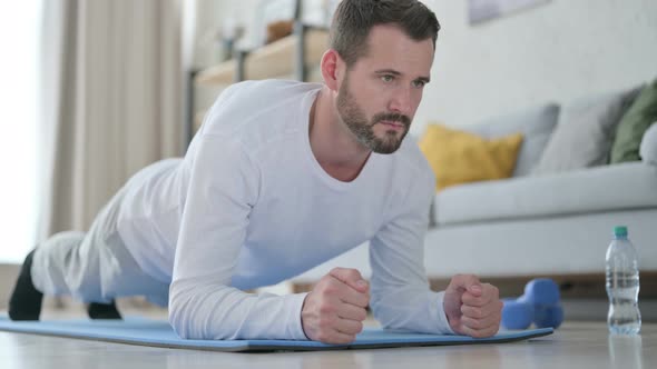 Close Up of Strong Man Doing Plank on Yoga Mat at Home