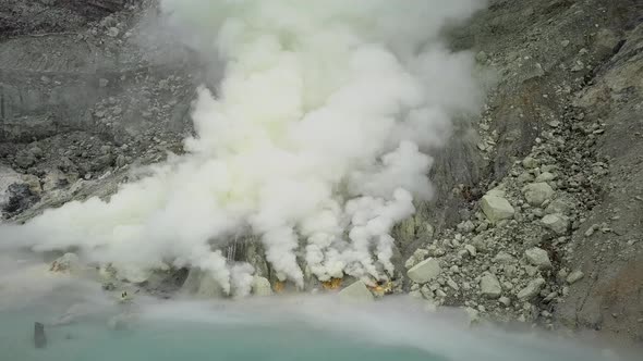 Sulfur Springs on the Lake in the Vent of a Sleeping Volcano Sulfur Smoke Comes Out From Under the