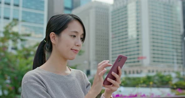 Woman check on smart phone in city