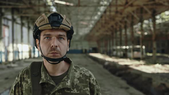 Man in Safety Helmet and Military Uniform Walking on Plant