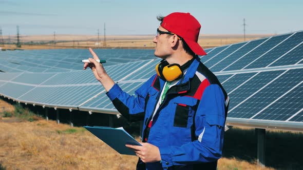 Repairman Is Observing Outdoors Solar Batteries