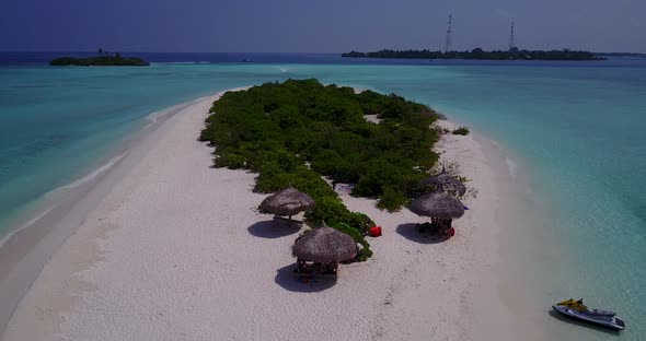 Wide flying travel shot of a white sandy paradise beach and aqua turquoise water background in vibra