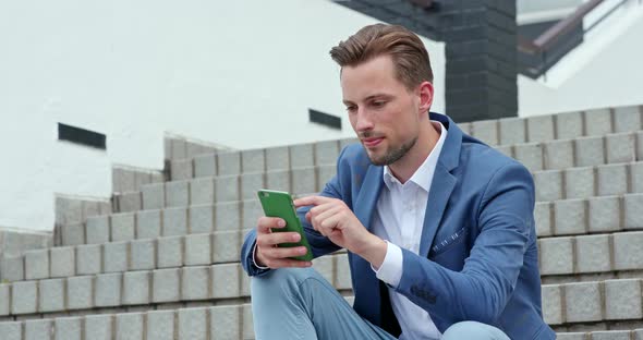 Caucasian Businessman Look at Mobile Phone in Hong Kong