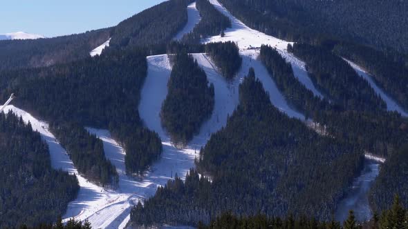 Snowy Slopes at a Ski Resort in Sunny Day. Skiers Going To the Mountains