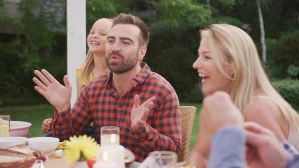 Three generation family enjoying lunch outdoors