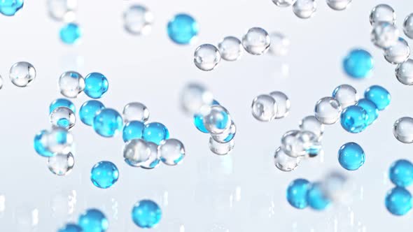 Super Slow Motion Shot of Blue and Transparent Hydrogel Balls Bouncing on Glass at 1000Fps