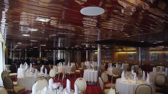 Beautiful View of Banquet Hall with Decorated Tables on Festive Day.