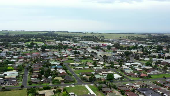 AERIAL Local Streets Of Country Coastal Township And Shopping Strip