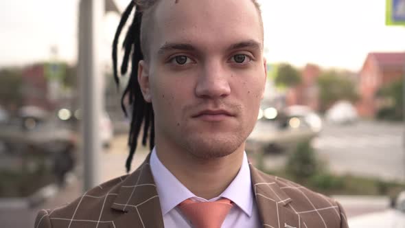 Portrait of a Young Modern Businessman or Manager in a Business Suit Outdoors