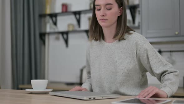 Young Woman Coming in and Opening Laptop at Home