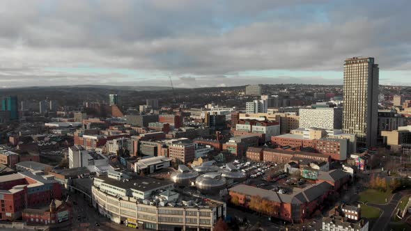 Drone shot above the city of Sheffield, panning over the Train Station, Sheffield Hallam, Park Hill