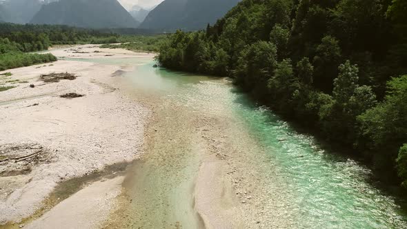 Aerial view of the Soca river with turquoise blue water in Slovenia.