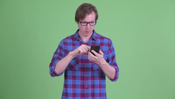 Stressed Young Hipster Man Using Phone and Getting Bad News