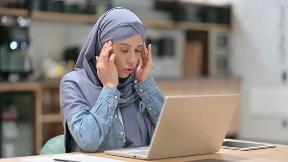 Arab Woman with Headache Using Laptop at Work 