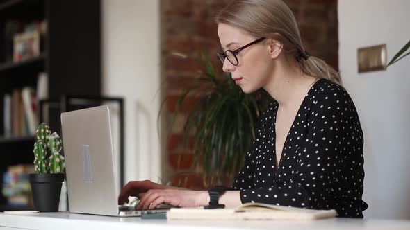 beautiful woman working on her laptop in home office