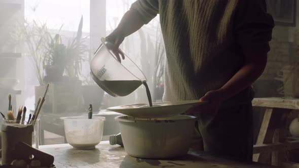 Woman Is Pouring Enamel On Plate