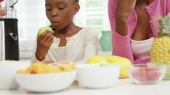 Mother and daughter having breakfast together