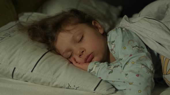 Cute Little Kid Girl Sleeping Well Alone in Bed