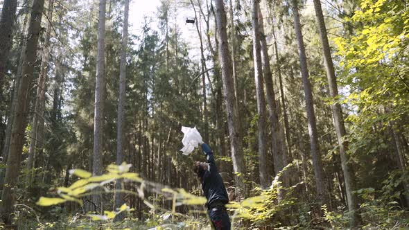 Lost Young Man Actively Waves White Rag to Attract the Attention of Rescuers