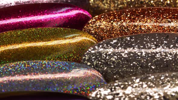 Collection of Glittering Nail Samples for Showing Assortment of Polishes for Gel Manicure in Macro
