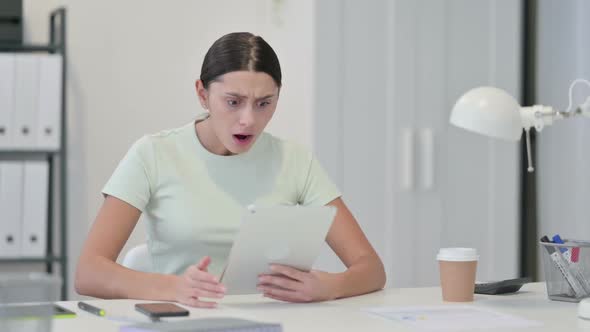 Young Latin Woman Reacting to Loss on Tablet