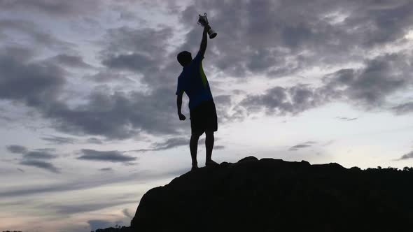 Silhouette Man Win On The Top With Trophy