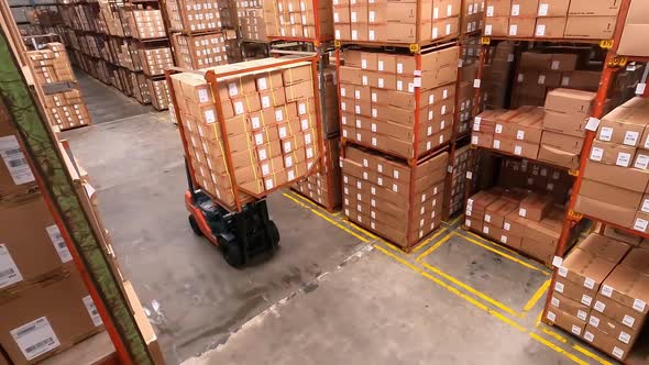 Birdseye View Of Forklift Truck With Boxes In Warehouse