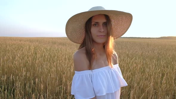 Amazing Portrait of Beautiful Woman Standing in Field of Ripe Golden Wheat