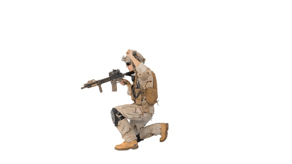 Soldier walking aiming with rifle and using radio on white