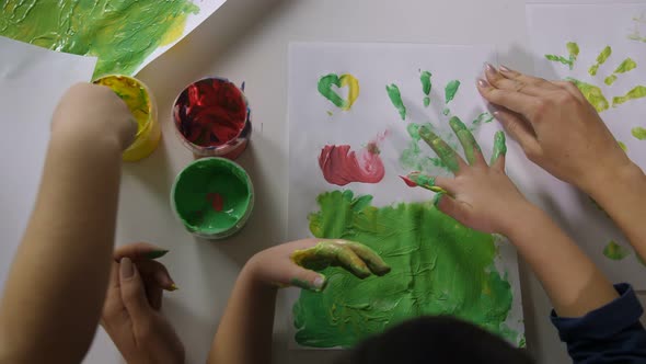 Children Hands Finger Painting with Various Colors