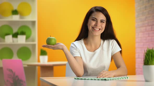 Smiling Beautiful Lady Holding Green Apple Hand Sitting Table, Health Care, Diet