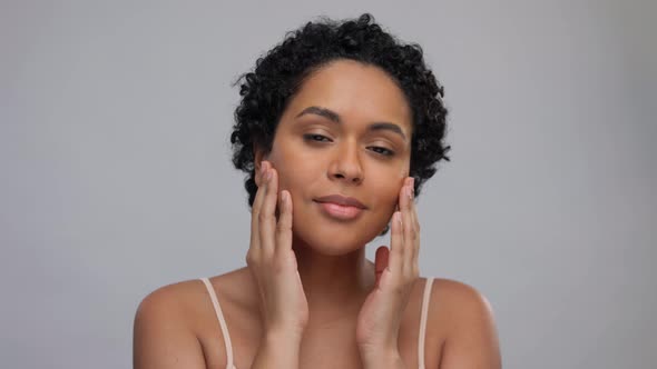 Portrait of Young Woman Touching Her Face