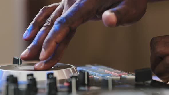 Closeup Unrecognizable DJ Man Spinning Record Vinyl Twist Disc Using Mixer Controller Desk for