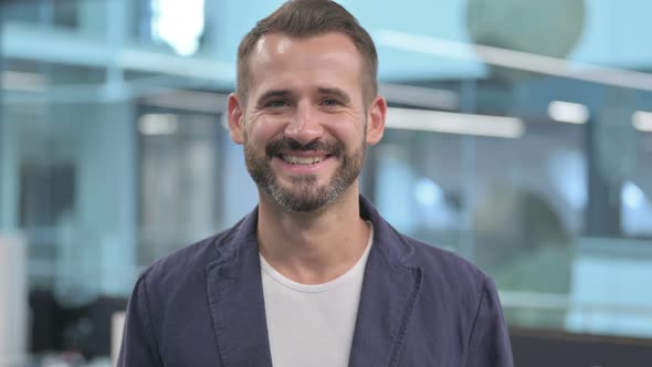 Middle Aged Businessman Smiling at Camera