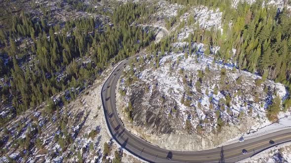 Aerial drone flyover of busy winter holiday traffic on windy Highway 50 in the Sierra Nevada mountai