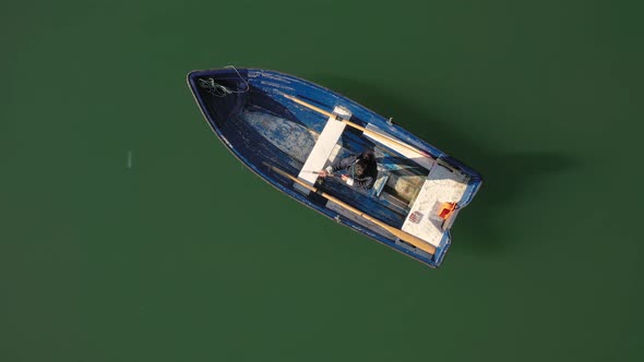 Woman on the Boat Catches a Fish on Spinning in Norway