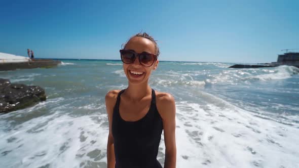 Closeup Happy Slim Woman in Swimwear Joyfully Running Into Waving Sea