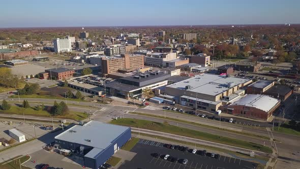 Slow colorful aerial shot of buildings and traffic in Muskegon, MI