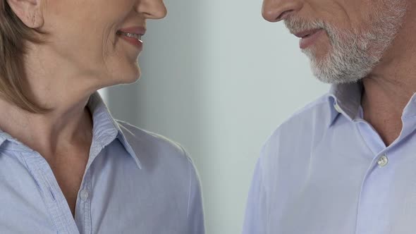 Married couple gently hugging looking in eyes to each other, family idyll