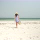 Young Woman Walks Barefoot On Beach Towards Ocean - VideoHive Item for Sale
