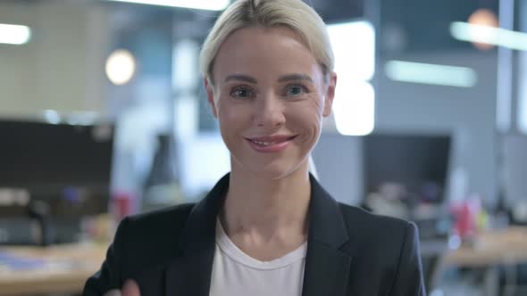 Portrait of Cheerful Businesswoman Showing Thumbs Up