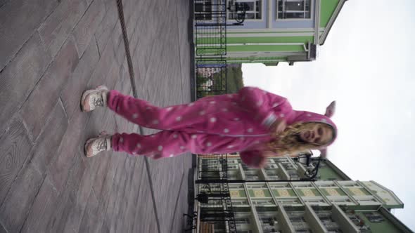 Wide Shot Joyful Dance of Cheerful Caucasian Girl in Pink Costume on City Street