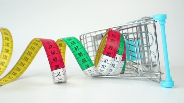 Bright multicolored centimeter in a fallen metal supermarket trolley