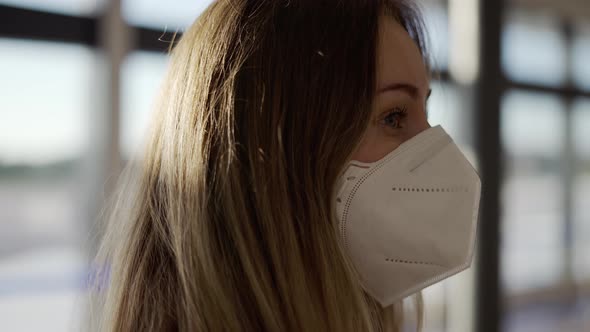 A Bit Confused Woman in Protective Mask Standing at the Airport