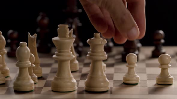 A Hand Moving a Chess Piece