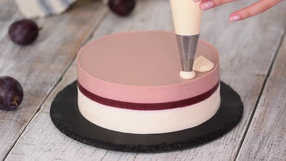 Pastry Chef Decorated a Delicious Plum Mousse Cake with Whipped Cream.