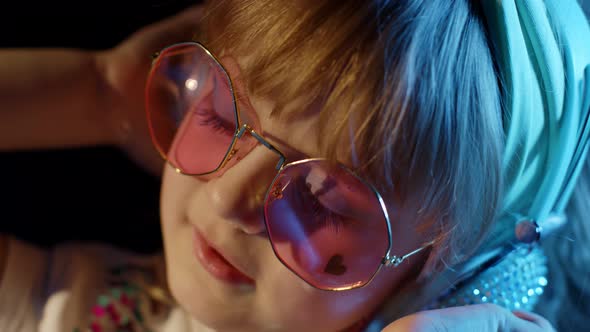 Portrait of Trendy Stylish Girl Looking at Camera Smiling Child Kid in Neon Light at Disco Club